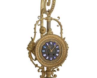 1371
Mid-19th century; France
A Napoleon III gilt-bronze wall clock
Marked to dial: Jules Graux & Cie. / Paris
The two-movement clock with blue enamel dial bearing Roman numeral hour markers, housed in a gilt-bronze case with opposed masks in relief, suspended from a scrolled wall mounting bracket
40.5" H x 16" W x 14" D approximately
Estimate: $600 - $800