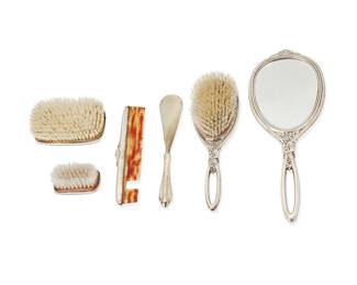 1324
Late 19th/early 20th century
A group of silver vanity items
The set marked for R. Blackington & Co. and for sterling; smallest brush marked: Webster Sterling
Comprising a three-piece set including a hand mirror, hairbrush, and comb, together with an associated shoehorn and two brushes, personalized, 6 pieces
Mirror: 13" L x 5" W; Smallest brush: 1.625" H x 3" W x 1.625" D
Estimate: $400 - $600