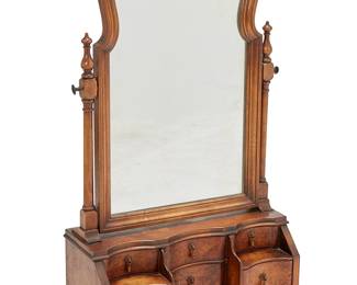 1437
Early 20th century
A Queen Anne-style vanity mirror
The walnut mirror with burlwood veneer, featuring six drawers with metal pulls, surmounted by a hinged mirror mounted on turned supports, raised on bun feet
Overall: 28" H x 17.75" W x 7.75" D
Estimate: $300 - $400