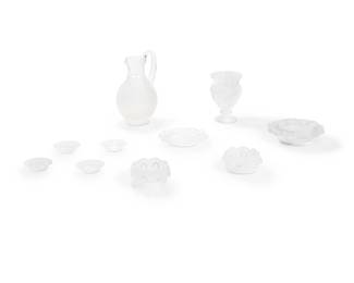 1342
Late 20th century
A group of Lalique glass table items
Each with etched script mark: Lalique ® France [post-1978]
The clear and frosted glass items, comprising a handled pitcher (9" H x 5.625" W x 4.875" D), a small urn-form footed vase (6" H x 4" Dia.), a pair of bowls (each: 2" H x 4.375" Dia.), one ashtray (5.875" Dia.), and four butter pats (each: 3.125" Dia.), together with an associated and conformingly designed unmarked bowl (6.5" Dia.), 10 pieces
Estimate: $600 - $800