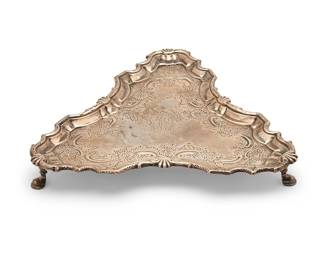 1322
1751
An English sterling silver salver
Marked for sterling and for London, and date marked for 1751; maker's mark: WP [in heart-shaped cartouche for maker William Peaston]; further marked with family crest at center
The tripod salver with chased and repoussé floral and foliate motifs, raised on three feet, personalized
1.25" H x 9.75" W x 9" D
14.2 oz. troy approximately
Estimate: $400 - $600