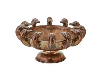 1332
Mid-20th century; Greece
A LALAoUNIS sterling silver bowl
Marked to foot: [maker's mark] / LALAoUNIS / Greece / 925 / [Greek letters]
The hammered vermeil sterling silver footed bowl with twelve duck heads to rim
3.625" H x 7.25" Dia.
13.5 oz. troy approximately
Estimate: $200 - $300