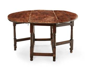 1481
19th century
An English mixed wood gateleg table
The carved wood table with drop leaf circular top raised on turned gatelegs joined by a box stretcher, set on double bun feet
Stored: 29.5" H x 47.75" W x 20.75" D; Open: 51.5" D
Estimate: $300 - $500