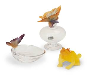 1351
Late 20th/early 21st century
Three Daum glass and pâte de verre table items
Each etched: Daum / France; tray with Daum sticker
Comprising a glass eau de parfum bottle with pâte de verre butterfly stopper (5.625" H x 3.75" W x 3.375" D; box: 4.75" H x 9.5" W x 4.75" D), a glass oval dish with mounted pâte de verre butterfly (3" H x 5" W x 3.375" D; box: 3.375" H x 6.25" W x 5.125" D), and a pâte de verre frog figure with mounted metal eyes (2.375" H x 3" W x 2.75" D; box: 3.25" H x 4.75" W x 4.75" D), each housed in original box, 3 pieces
Estimate: $200 - $400