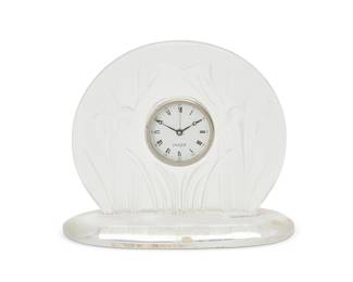 1346
Late 20th/early 21st century
A Lalique glass "Iris" clock
With etched script mark: Lalique ® France [post-1978]; with sticker applied: Lalique / Paris; dial marked: Lalique ®; movement marked: 3637
The quartz movement clock with Arabic minute and Roman numeral hour markers, set in a molded and frosted glass frame
Overall: 6.75" H x 8" W x 3.5" D
Estimate: $200 - $400
