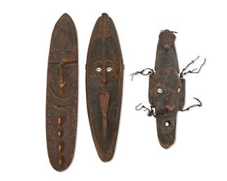1427
20th century; Papua New Guinea
Three Papuan carved wood masks
Comprising three masks, one with animal figure headpiece and twine accents, two mounted with cowrie shell eyes, 3 pieces
Longest: 26" H x 5.25" W x 2.5" D; Shortest: 19" H x 6" W x 4.75" D
Estimate: $300 - $500