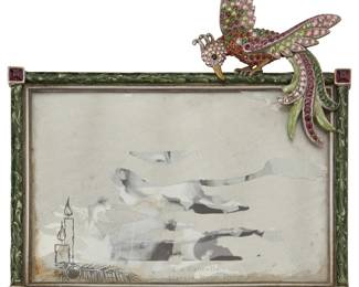 1353
Late 20th/early 21st century
A Jay Strongwater jeweled and enameled picture frame
With maker's mark verso: JAY STRONGWATER ®
The frame with cut glass jewels set in enamel and easel backing, featuring a jeweled bird figure
7" H x 6.5" W x 0.875" D
Estimate: $200 - $400