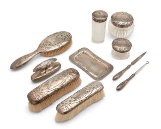 1330
1851-1907
An assembled Gorham vanity set
Each marked for Gorham and for sterling; jar lids and tray dated marked for 1907; brushes marked for 1851-57; three more marked for 1869
Comprising three weighted sterling brushes, three glass vessels with sterling lids, a small tray, a nail file, a nail buffer, and a boot hook, personalized, 10 pieces
Largest brush: 9.75" L x 3.25" W x 1.25" D
Lids and tray: 4.8 oz. troy approximately
Estimate: $300 - $500