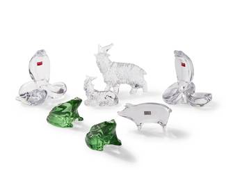 1339
Late 20th/early 21st century
A group of Baccarat glass animal figures
Each marked with stencil or script mark, some with Baccarat sticker
Comprising two cobra figures (each: 6.375" H x 6" W x 4.75" D; each box: 8.125" H x 9" W x 9" D), two green-tinted frog figures (each: 2.875" H x 3.875" W x 3.25" D; box: 3.875" H x 6.25" W x 5.875" D), a standing goat figure (5.875" H x 6" W x 2.75" D; box: 4.75" H x 9.5" W x 8.75" D), a recumbent goat figure (3.25" H x 3.875" W x 2" D; box: 3.75" H x 5.875" W x 6.375" D), and a pig figure (2.75" H x 5.25" W x 1.5" D; box: 4" H x 6.25" W x 6" D), each housed in original box, 7 pieces
Estimate: $400 - $600