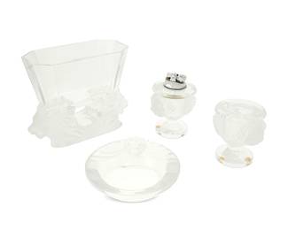 1344
Mid/late 20th century
Three Lalique glass smoking items and "Venise" vase
Each etched to underside: Lalique ® France [post-1978]
Each with frosted elements and depicting lion head in relief, comprising three "Tête de Lion" smoking items including one table lighter (4.625" H x 3.875" W x 3.25" D), one cigarette holder (3.875" H x 3.875" W x 3.25" D), and one ashtray (2.25" H x 5.75" Dia.), together with a "Venise" vase (6.375" H x 8.25" W x 3.75" D, 4 pieces
Estimate: $300 - $500