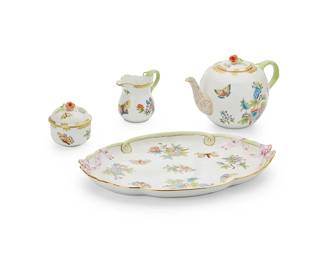 1358
Mid/late 20th century
A Herend porcelain "Queen Victoria" tea set
Each marked in blue: Herend / Hungary / Handpainted
Comprising a teapot (5.375" H x 10.5" W x 6.25" D), a handled creamer (4.125" H x 5.375" W x 3.25" D), and a lidded sugar (3.75" H x 3.625" D), all set on a tray (1.625" H x 16" W x 11.25" D), 4 pieces
Estimate: $300 - $500