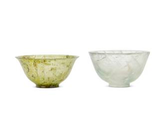 1378
20th century
Two carved hardstone bowls
The translucent stone footed bowls comprising one clear and one green hardstone, 2 pieces
Clear: 2.25" H x 3.875" Dia.; Green: 1.875" H x 4" Dia.
Estimate: $100 - $150