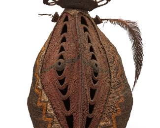 1428
20th Century; Sepik River region, Papua New Guinea
An Abelam "bapamini" yam mask
The polychrome basketry ceremonial mask with painted geometric designs and feather accents, meant to be placed atop large yams
21.5" H x 12.5" W x 18" D approximately
Estimate: $200 - $400
