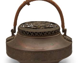 1398
20th century
A Japanese brass handled censer
The censer with openwork lid depicting a dragon figure, featuring a cord-wrapped handle with butterflies in relief mounted at handle junctures
Overall: 16.625" H x 11.5" Dia.
Estimate: $300 - $500