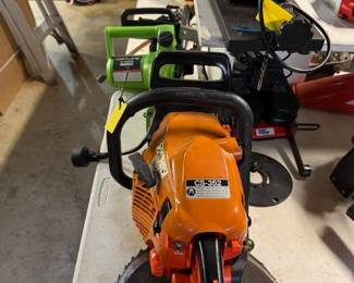 Orange Chainsaw.         Green Electrical Chainsaw