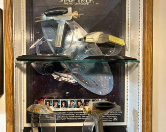 Star trek poster appears to be fastened to the wall and removing could cause damage. Just the phasers are for sale.