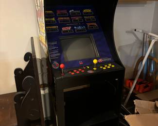 The table on the floor to the left of this pic-the family decided to keep. Only the Midway arcade machine in this picture is for sale. And it works!