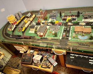 Huge HO scale train model town built into home, takes up two walls! 