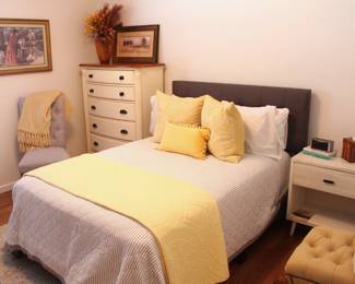 Room full of inexpensively priced bedroom furniture.