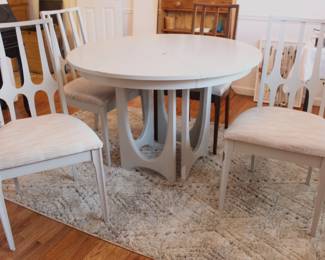 BUY IT NOW!  $495.00.  Mid Century Modern  44" round table with four chairs and two leaf's.  Three are painted, one is not.