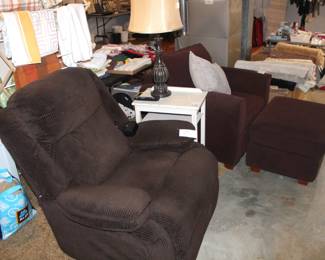 Brown upholstered recliner and brown upholstered club chair with ottoman.