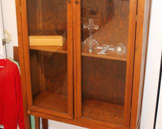 Glass front cabinet. 13" d x 38 1/4" w x 60" h.