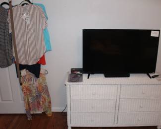 Wicker chest of drawers and Vizio TV.