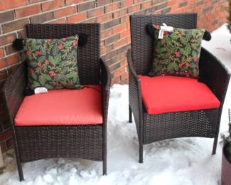 Pair of outdoor chairs with cushions and pillows.