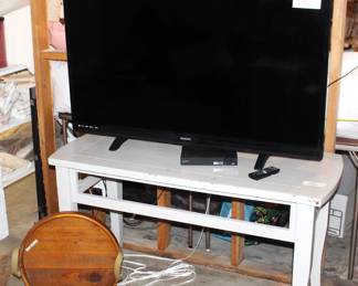 50" Phillips flat screen TV.  White table.