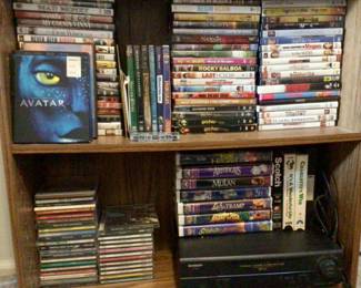 VHS player, DVDs, Blue-Rays, CDs, and VHS tapes