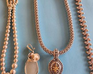 Silver Necklace on the Left. Pendant. Necklace with Pendant. Silver Bracelet.
