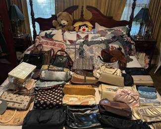 Multiple bags/purses/wallets. Quilts, pillows, wooden bed frame and mattress, teddy bear, lamps