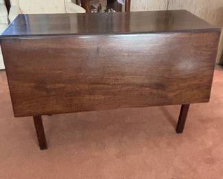 Deep Drop Leav Walnut table.  Legs swing out to hold leaves