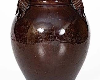 Glazed Redware Jar, probably TN or Southwestern VA, second or third quarter 19th century, ovoid jar with footed base, coved rim, and heavily-ribbed, semi-open strap handles, the surface covered in a reddish-brown lead-and-manganese glaze. Provenance: Purchased by Wahler at Case Antiques Auctions & Appraisals, Knoxville, TN, Dec 6th, 2008, lot 103. A few chips to each handle. Surface wear to body of jar. A 1/2" flake to midsection on one side. A faint 1 1/2" line from rim. Rim with wear, a small chip, and a few minor nicks. Two base chips. H 11 1/4". ($800-$1200)
