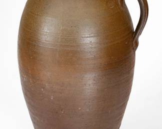 Very Rare Salt-Glazed Stoneware Honey Jar, Stamped "J.L," James LaFever, Sr. (1816-1882), White County, TN origin, mid 19th century, ovoid jar with heavily-tooled shoulder, semi-rounded rim, and applied strap handle, the surface covered in a salt glaze over a mottled brown-to-gray ground. Impressed with raised-face "J.L" maker's mark within an oval, sawtoothed border at shoulder. Literature: For more information on LaFever, see Smith and Rogers, Tennessee Potters, Pots, and Potters, 1790s to 1950, Vol.2, pp. 789-790. Four tight cracks from rim, including a 7 1/2" inverted Y-shaped crack, and 6 3/4", 4", and 2" cracks. A 3/4" rim chip. Flakes, crazing, and light wear to surface and underside, some of which has been sealed. Minor chipping to base. H 17 1/4". ($300-$500)
