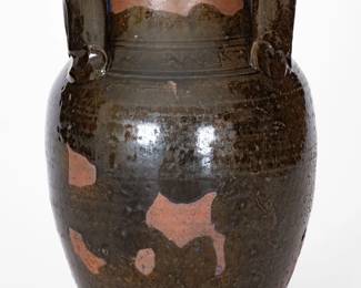 Glazed Redware Jar, Eastern TN origin, second or third quarter 19th century, ovoid jar with tall collar, flattened rim, and applied strap handles with triply-depressed terminals, the shoulder decorated with an incised wavy line between pairs of straight incised lines. Surface covered in a mottled, olive-colored lead-based glaze. Provenance: Ex-Marcus King. Glaze skips to surface, as-made. Significant glaze loss and pitting from use to base area. Shallow chipping to base. A 7/8" flake to rim. Surface wear to glaze. Traces of old blue paint to surface. H 10". ($400-$600)
