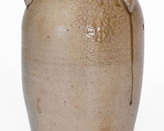 Salt-Glazed Stoneware Jar, attributed to the Craven Family, Henderson County, TN, circa 1830-1865, ovoid jar with flattened rim and large lug handles, the surface covered in a salt glaze with heavier concentrations descending from the shoulder. A 1 1/8" rim chip and minor rim nick. A thin 1 1/2" surface crack to one handle. An approximately 2" hairline to base with surface crazing to exterior ascending from it. Additional surface craziing to exterior. Exfoliation to interior. H 14 1/4". ($200-$300)

