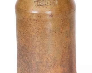 One-Gallon Salt-Glazed Stoneware Jar, Stamped "1872," attributed to the Grindstaff Pottery, Blount County, TN, circa 1872, cylindrical jar with tapered shoulder and semi-rounded rim, impressed at the shoulder with a raised-face "1872" stamp and one-gallon capacity mark. Surface with streaky slip coating and clear salt glaze. Exhibited: Tennessee Turned, Earthenware and Stoneware Made in East Tennessee 1800-1900, Museum of East Tennessee History, May 16-October 30, 2011. Literature: Illustrated in Wahler, Tennessee Turned, Earthenware and Stoneware Made in East Tennessee 1800-1900, Part One, p. 24, fig. 6, p. 188, fig. 6. Very nice condition, the rim with two minor in-the-firing pings, the base with wear and a few minor nicks. H 10 1/4". ($300-$500)
