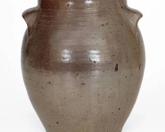 Salt-Glazed Stoneware Jar, attributed to the Craven Pottery, Henderson County, TN, circa 1840-1860, ovoid jar with heavily-tooled shoulder, semi-rounded rim, and distinctive flattened pocket handles, the surface coated in a streaky salt glaze. Measures approximately four gallons. Exhibited: Tennessee Turned, Earthenware and Stoneware Made in East Tennessee 1800-1900, Museum of East Tennessee History, May 16-October 30, 2011. Excellent condition with some minor in-the-firing flaws. H 14 1/4". ($150-$250)
