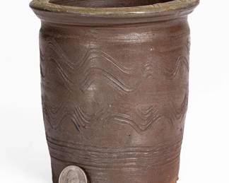 Salt-Glazed Stoneware Jar with Elaborate Incised Decoration, attributed to the Moses P. Harmon Pottery, Greene County, TN, circa 1880-1900, flaring, semi-ovoid jar with flattened rim, decorated with wavy incised combing to the body, underscored by a straight band of combing. Additional wavy combing to top of rim. Minor base chips and a small in-the-making dent to bottom edge. H 5 1/2". ($150-$250)
