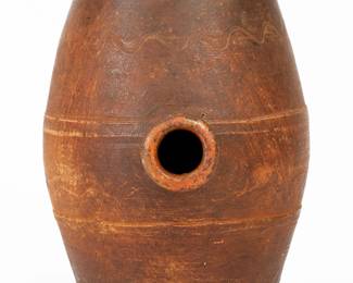 Redware Rundlet, probably TN origin, 19th century, barrel-form with raised banding and incised wavy line decoration, the midsection fitted with a tubular spout. Made with an unglazed exterior and lead-glazed interior. Excellent condition with some light wear. H 7 1/2". ($200-$300)
