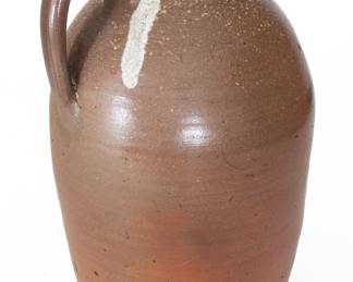 Three-Gallon Salt-Glazed Stoneware Jug, attributed to the Grindstaff Pottery, Blount County, TN, circa 1870-1900, ovoid jug with tooled spout, and glass run to upper handle terminal, the surface covered in a clear salt glaze. Impressed with raised-face three-gallon capacity mark to shoulder. Exhibited: Tennessee Turned, Earthenware and Stoneware Made in East Tennessee 1800-1900, Museum of East Tennessee History, May 16-October 30, 2011. Literature: Illustrated in Wahler, Tennessee Turned, Earthenware and Stoneware Made in East Tennessee 1800-1900, Part One, p. 22, fig. 2, p. 46, pl. 4, and p. 187, fig. 2. Provenance: Purchased by Wahler from John Carbosco in Newberry, S.C. Excellent condition with a minor chip to underside at edge. H 16 1/2". ($200-$300)
