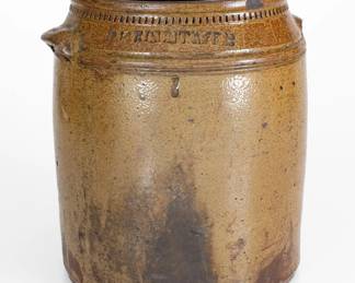 Two-Gallon Salt-Glazed Stoneware Jar, Stamped "W. GRINSTAFF:," Grindstaff Pottery, Blount County, TN, circa 1870-1890, wide, cylindrical jar with tooled shoulder, semi-squared rim, and small lug handles, decorated below the rim with dentile coggling. Surface covered in a heavy salt glaze over brown slip, resulting in a greenish "frogskin" coloration. Exhibited: Tennessee Turned, Earthenware and Stoneware Made in East Tennessee 1800-1900, Museum of East Tennessee History, May 16-October 30, 2011. Literature: Illustrated in Wahler, Tennessee Turned, Earthenware and Stoneware Made in East Tennessee 1800-1900, Part One, p. 32, fig. 18, p. 45, pl. 3, p. 94, and p. 190, fig. 18. Rim chips. Rim is out-of-round. In-the-firing, glazed-over losses to proper left handle. Small base chips. H 10 1/4". ($400-$600)
