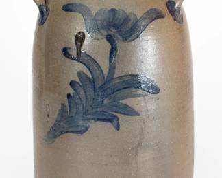 Scarce Five-Gallon Stoneware Churn with Cobalt Tulip Decoration, attributed to the Decker Pottery, Washington County, TN, circa 1872-1910, tapering churn with flared collar and ribbed lug handles, brush-decorated on the front and reverse with a large tulip motif featuring splayed petals. Cobalt highlights to handle terminals. Impressed "5" on front and reverse shoulder. Exhibited: Tennessee Turned, Earthenware and Stoneware Made in East Tennessee 1800-1900, Part One, Museum of East Tennessee History, May 16-October 30, 2011. A 1 1/8" rim flake. A 3/4" in-the-firing surface chip to midsection. An in-the-firing contact mark and salt drip to opposing side. A matte glaze drip descending one side. Minor chipping to rim. H 16 1/2". ($600-$800)
