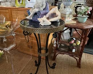 Gilt bronze and iron gueridon, black stone top.