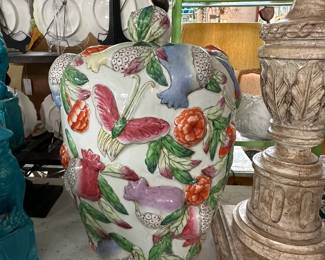 Colorful Chinese export lidded urn with garden motif raised relief.