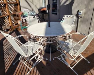 WHITE WROUGHT IRON PATIO SET WITH FOUR SPRING ACTION CHAIRS $150, UMBRELLA AND BASE $50
