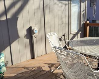 WHITE WROUGHT IRON PATIO SET WITH FOUR SPRING ACTION CHAIRS $150, UMBRELLA AND BASE $50