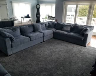 Crate & Barrel 4-piece blue sectional sofa. L-section: one section 70" long; one section 32" long; one section is a 90 degree corner 43" x 43"; one section 70" long - all 42" deep.