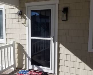 Storm door; entry door; exterior light fixtures